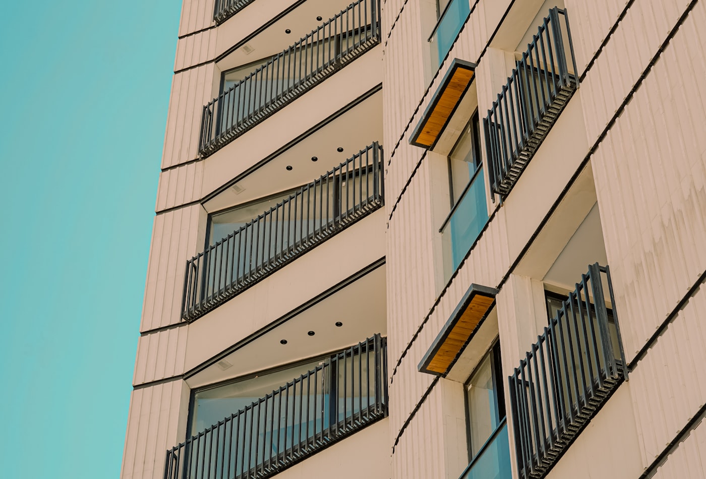Modern multi-family apartment building against a clear sky